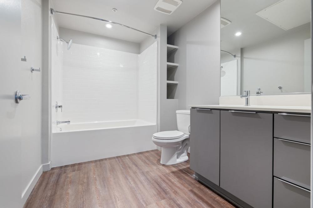 Bathroom with wood flooring at The George Apartment Homes in Anaheim, California