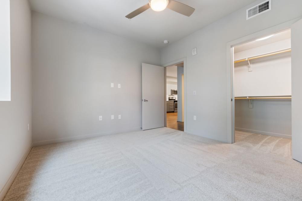 Carpeted unfurnished bedroom at The George Apartment Homes in Anaheim, California