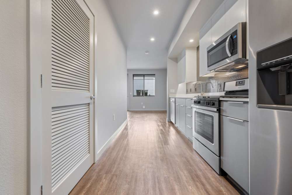 Kitchen with gray cabinetry at The George Apartment Homes in Anaheim, California
