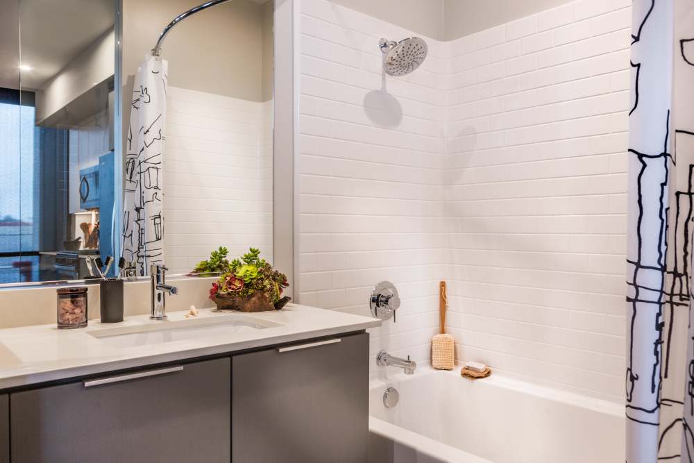 Bathroom with large mirror at The George Apartment Homes in Anaheim, California