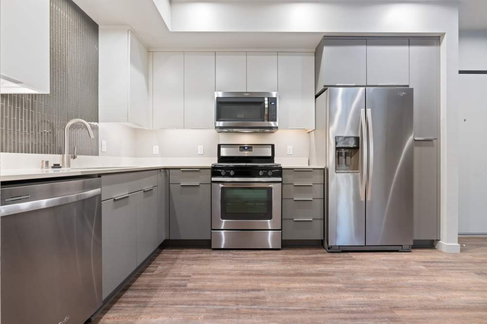 Kitchen with stainless-steel appliances at The George Apartment Homes in Anaheim, California