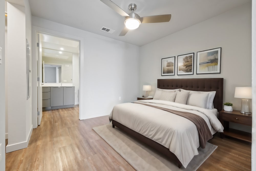 Bedroom with wood flooring at The George Apartment Homes in Anaheim, California
