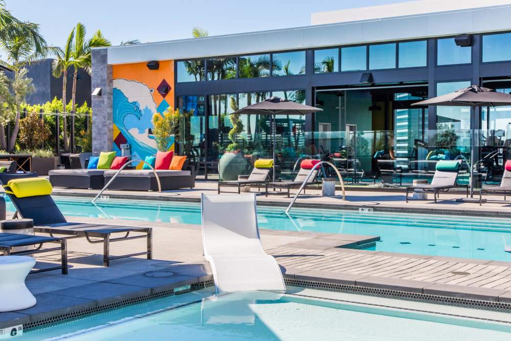 Swimming pool with loungers at The George Apartment Homes in Anaheim, California