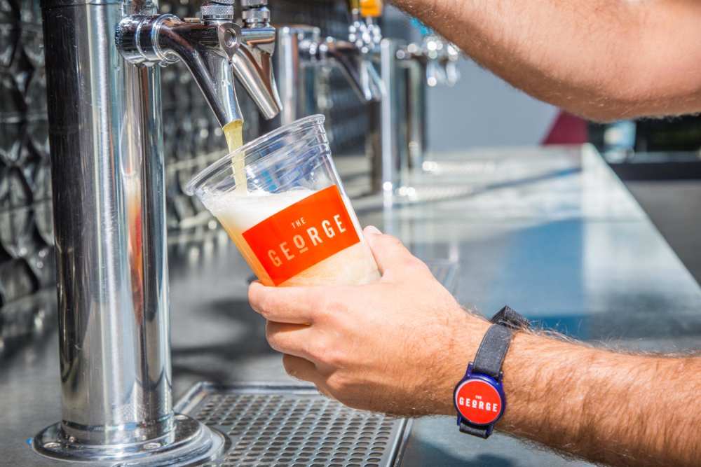 Bartender pouring a beer at The George Apartment Homes in Anaheim, California