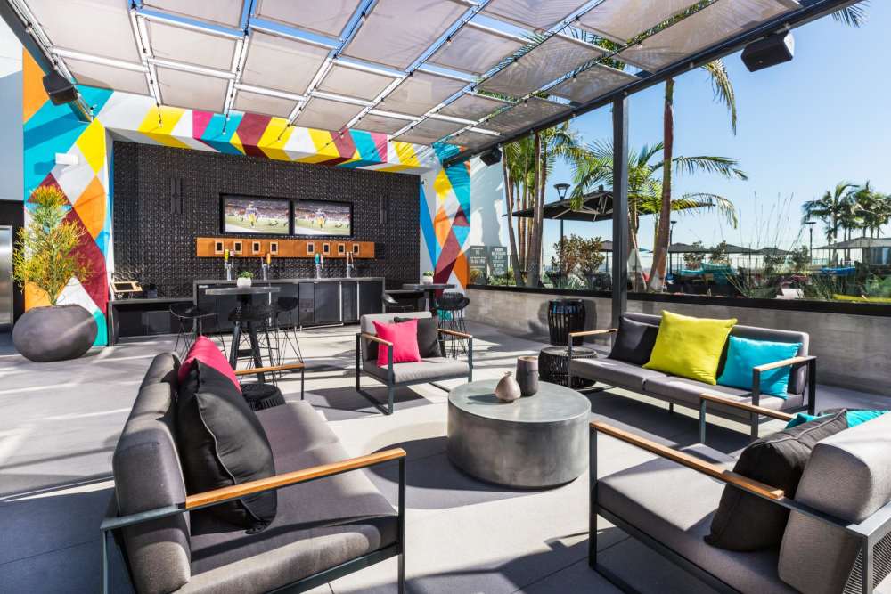 Outdoor lounge area and bar at The George Apartment Homes in Anaheim, California