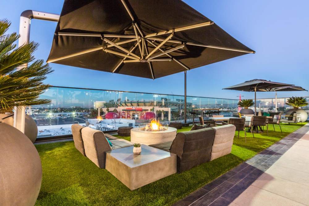 Shaded seating by the pool at The George Apartment Homes in Anaheim, California