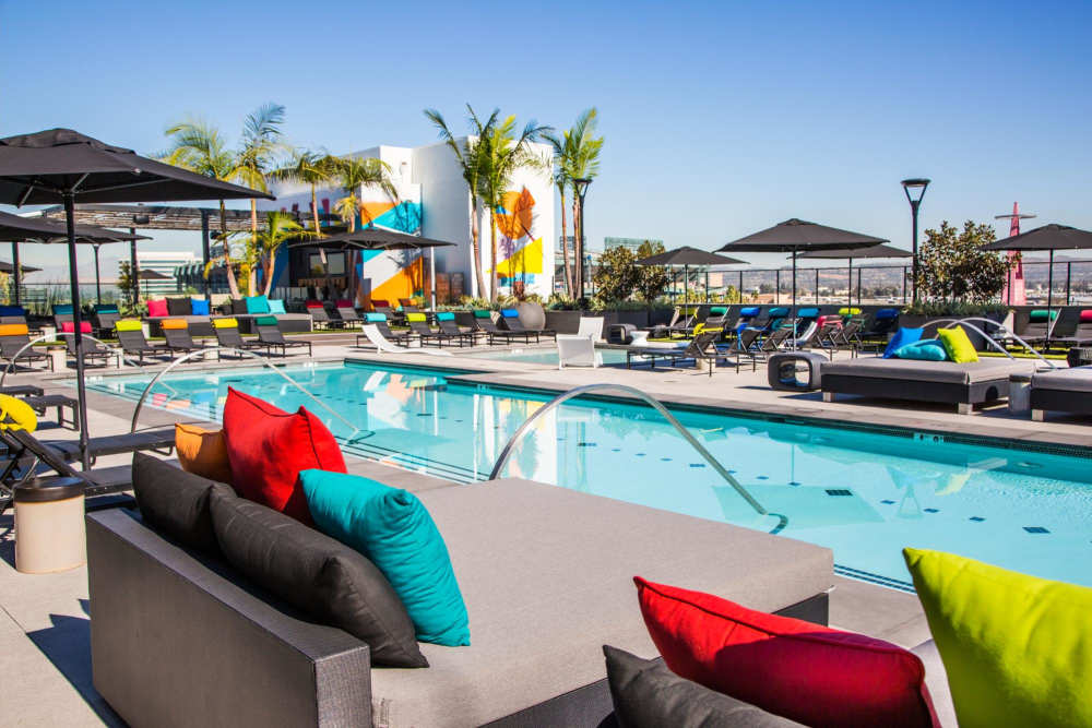 Lounge chairs by the pool at The George Apartment Homes in Anaheim, California