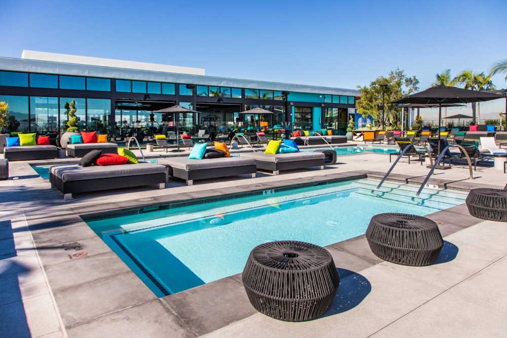 Seats by the pool at The George Apartment Homes in Anaheim, California