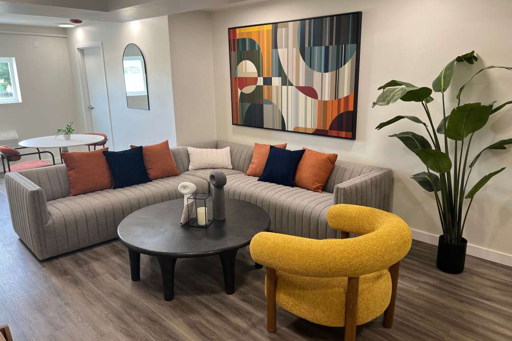 A cozy living room featuring a couch, chair, and table at Broadview Apartments in Columbia, South Carolina.