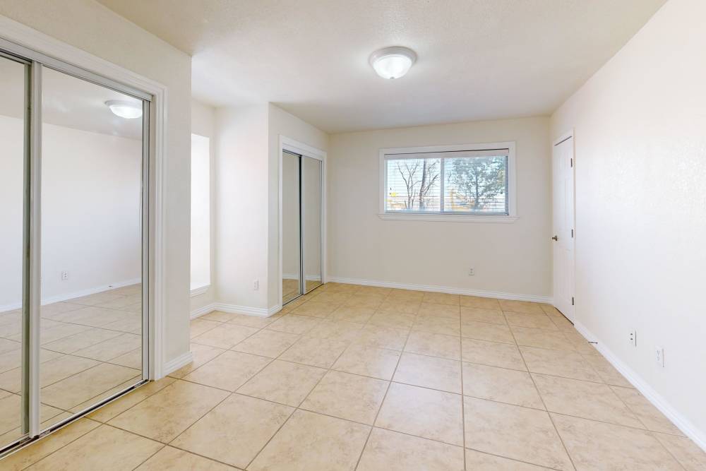 Bright bedroom with walk-in closets at Tucasa Townhomes in Irving, Texas,
