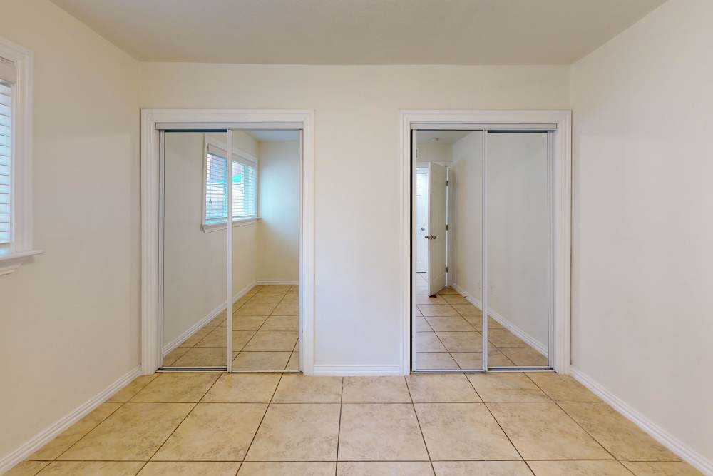 Bedroom with closets at Tucasa Townhomes in Irving, Texas
