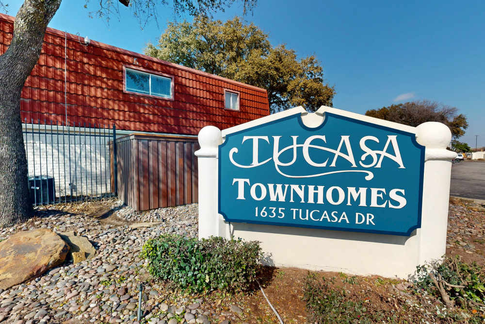 Welcome sign at Tucasa Townhomes in Irving, Texas