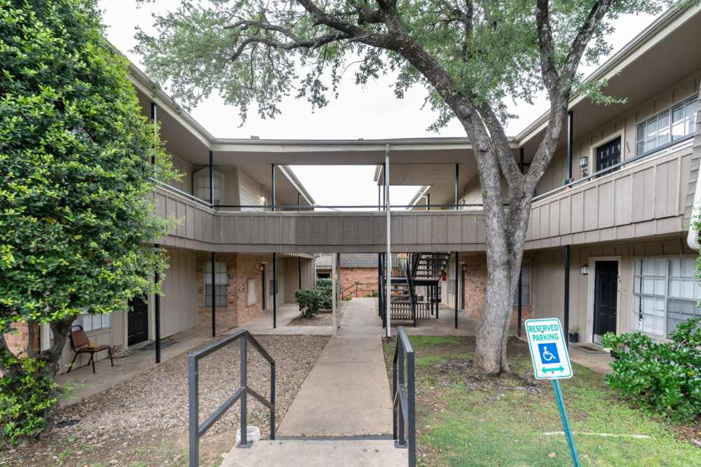 Kitchen with black appliances at Arbor Park Apartments in Hurst, Texas