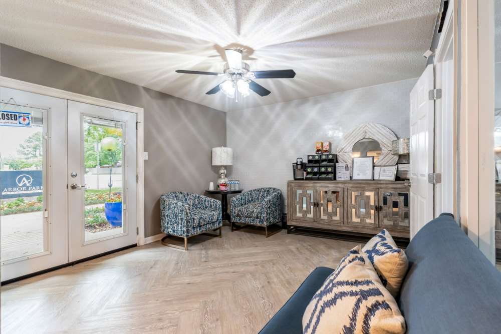 Cozy living room with view of kitchen at Arbor Park Apartments in Hurst, Texas