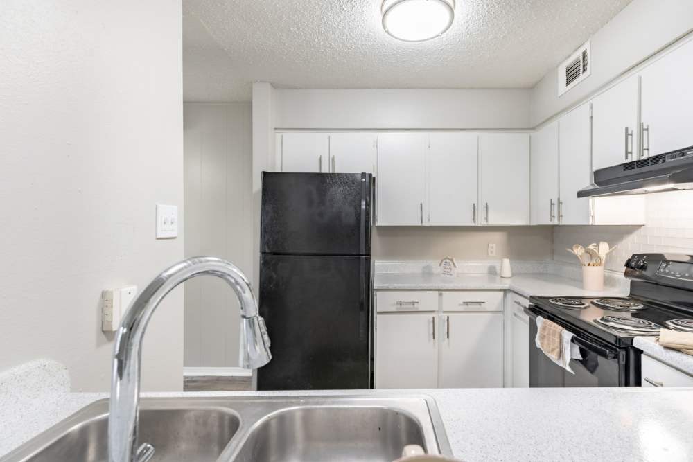 Kitchen sink at Arbor Park Apartments in Hurst, Texas