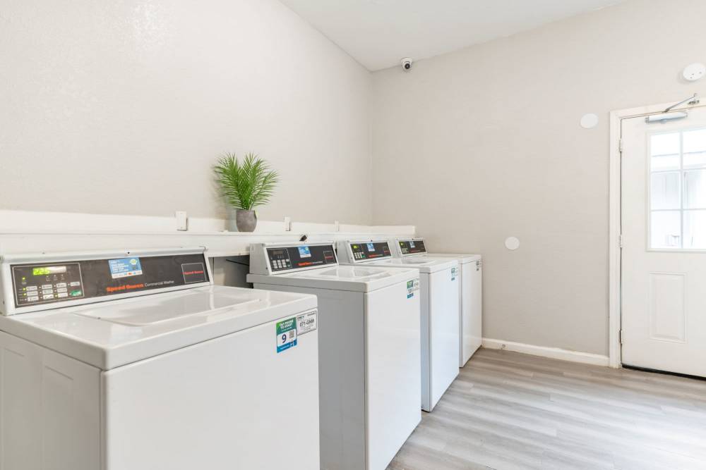 Laundry machines at Arbor Park Apartments in Hurst, Texas