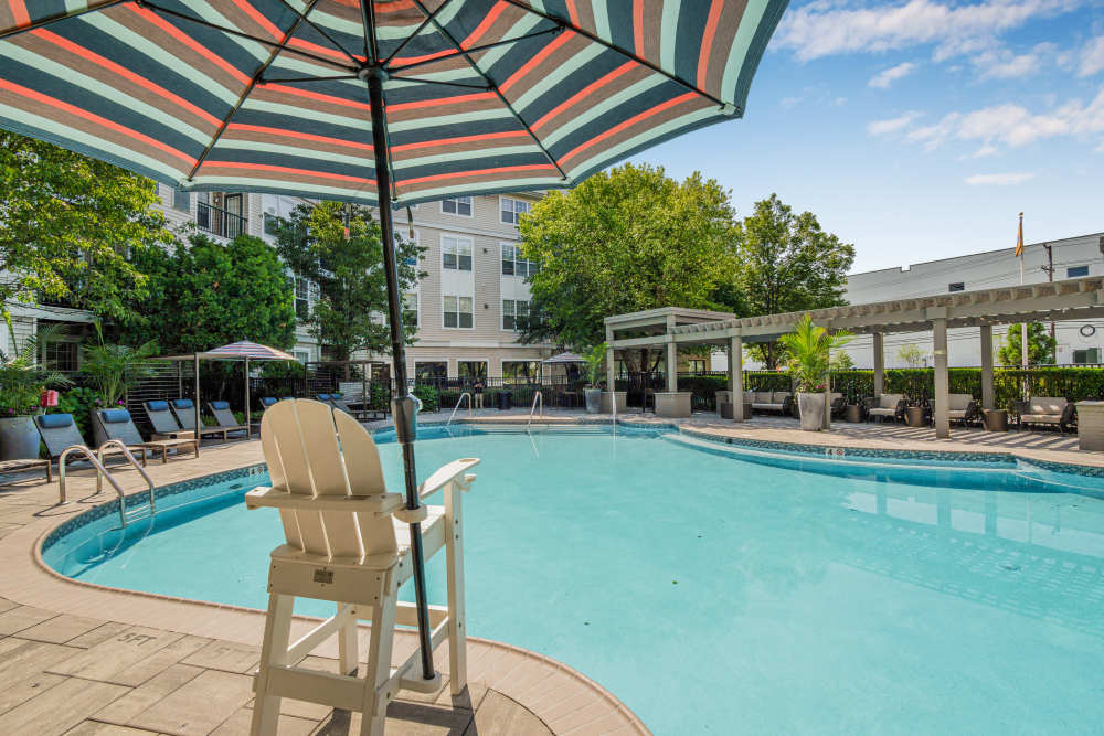 Resort style swimming pool with tons of seating to relax next to the pool at Sofi Lyndhurst in Lyndhurst, New Jersey
