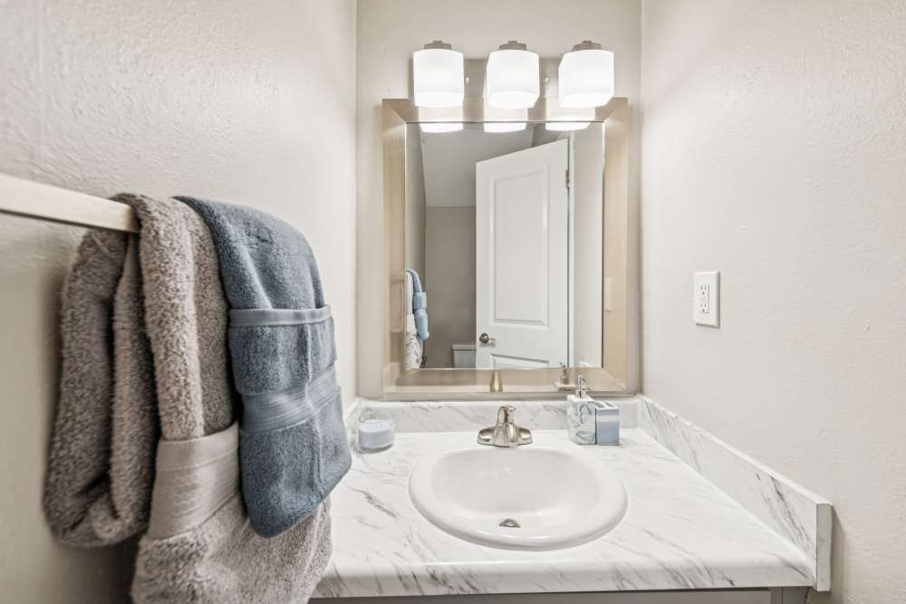 Washer with vanity mirror inside the bathroom at Pinewood Station in Hillsborough, North Carolina