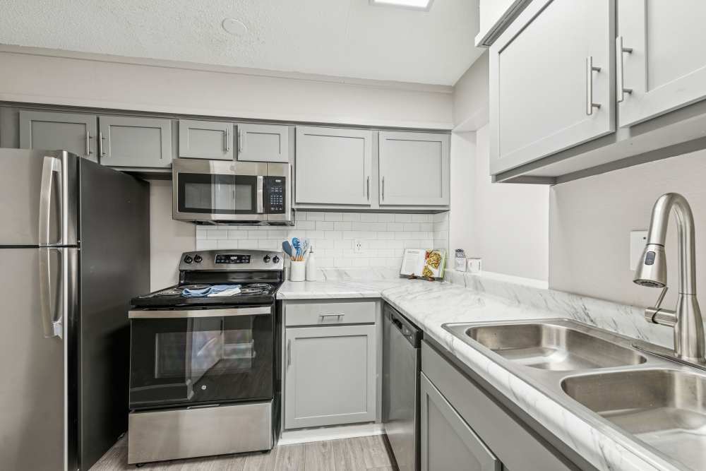White-painted kitchen with many cabinets at Pinewood Station in Hillsborough, North Carolina