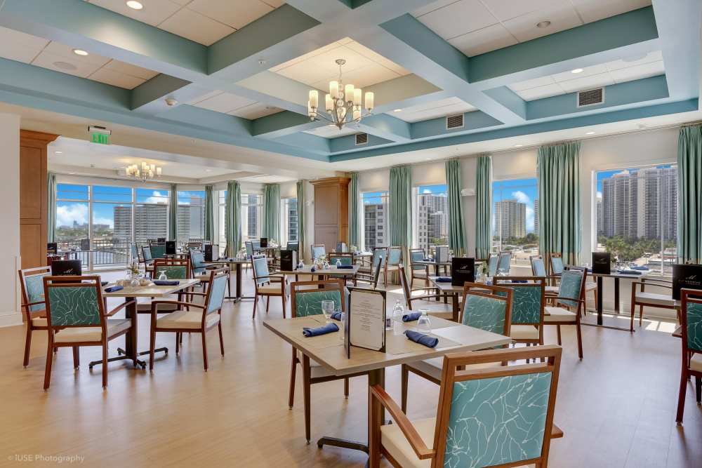 Stylish clubhouse interior with cozy seating and ambient lighting at The Meridian at Waterways in Fort Lauderdale, FL
