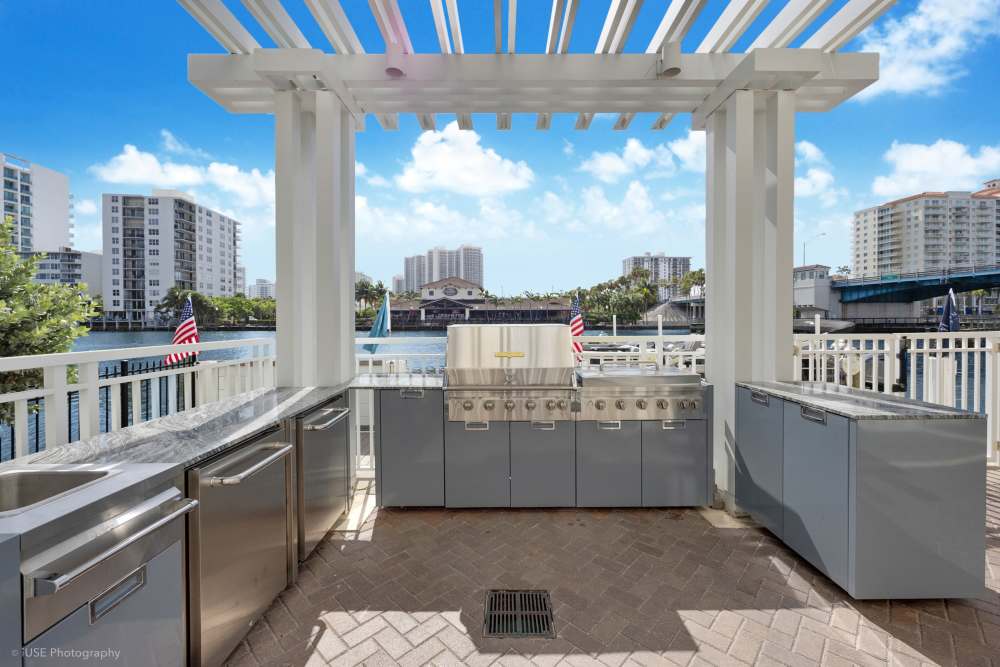 Sunlit apartment exterior showcasing patios with a beautiful view at The Meridian at Waterways in Fort Lauderdale, FL