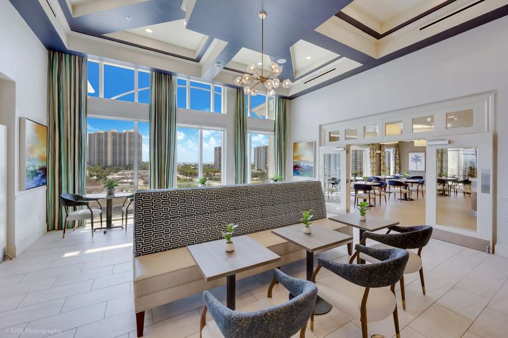Modern community clubhouse with open lounge and entertainment area at The Meridian at Waterways in Fort Lauderdale, FL