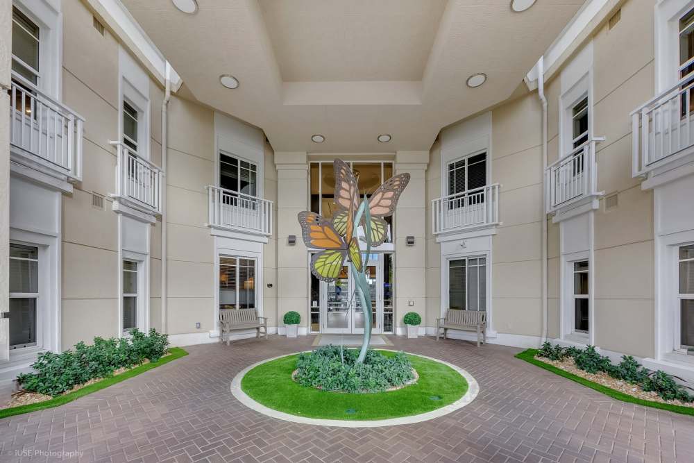 Apartment center with lush greenery at The Meridian at Waterways in Fort Lauderdale, FL