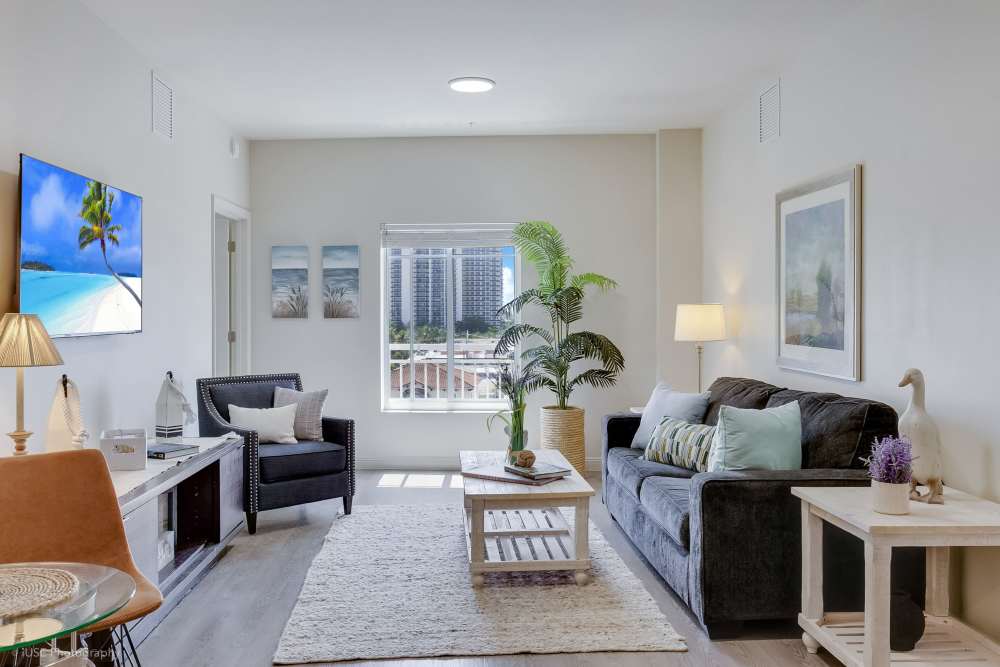 Living room setup with minimalist style and contemporary furniture at The Meridian at Waterways in Fort Lauderdale, FL