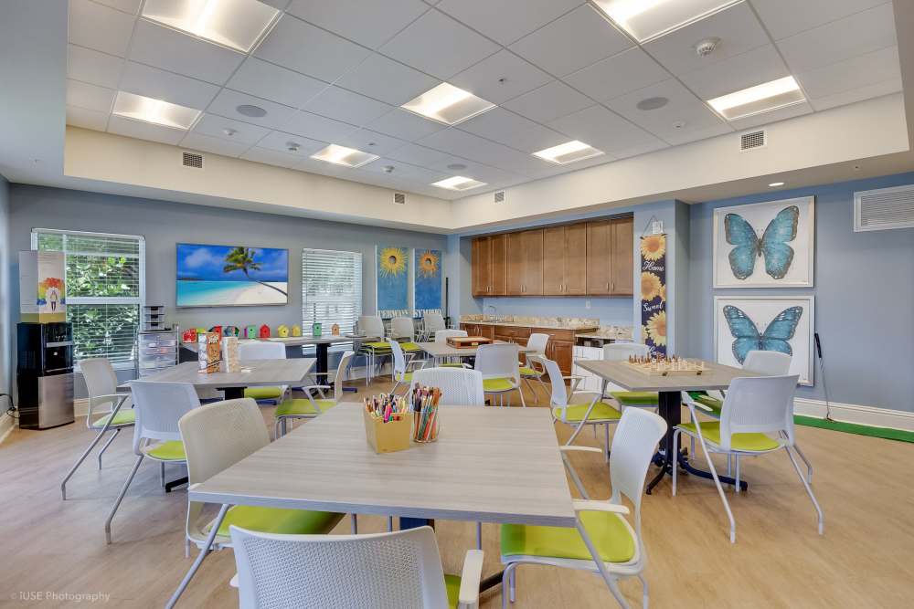 Shared office with large tables and collaborative seating at The Meridian at Waterways in Fort Lauderdale, FL