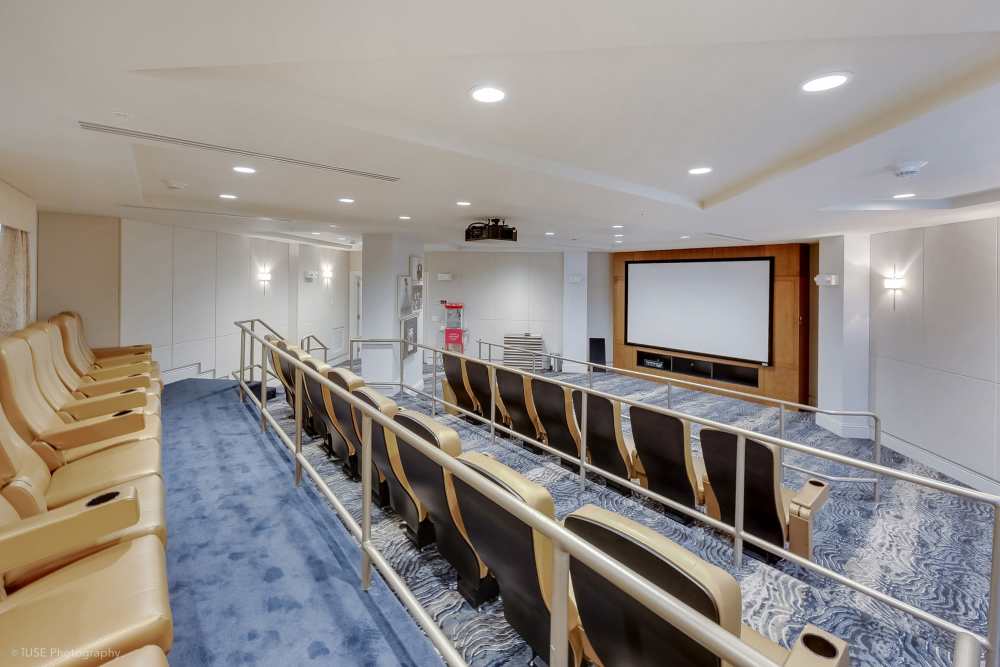 Modern mini theatre setup with popcorn machine and cozy seats at The Meridian at Waterways in Fort Lauderdale, FL