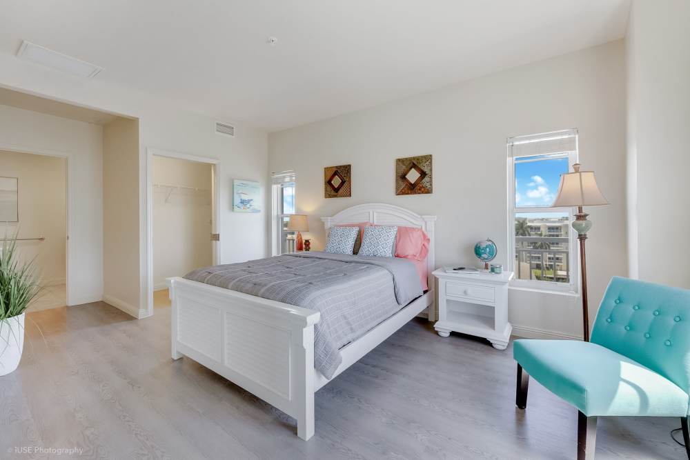 Peaceful bedroom retreat with ambient lighting and soft linens at The Meridian at Waterways in Fort Lauderdale, FL