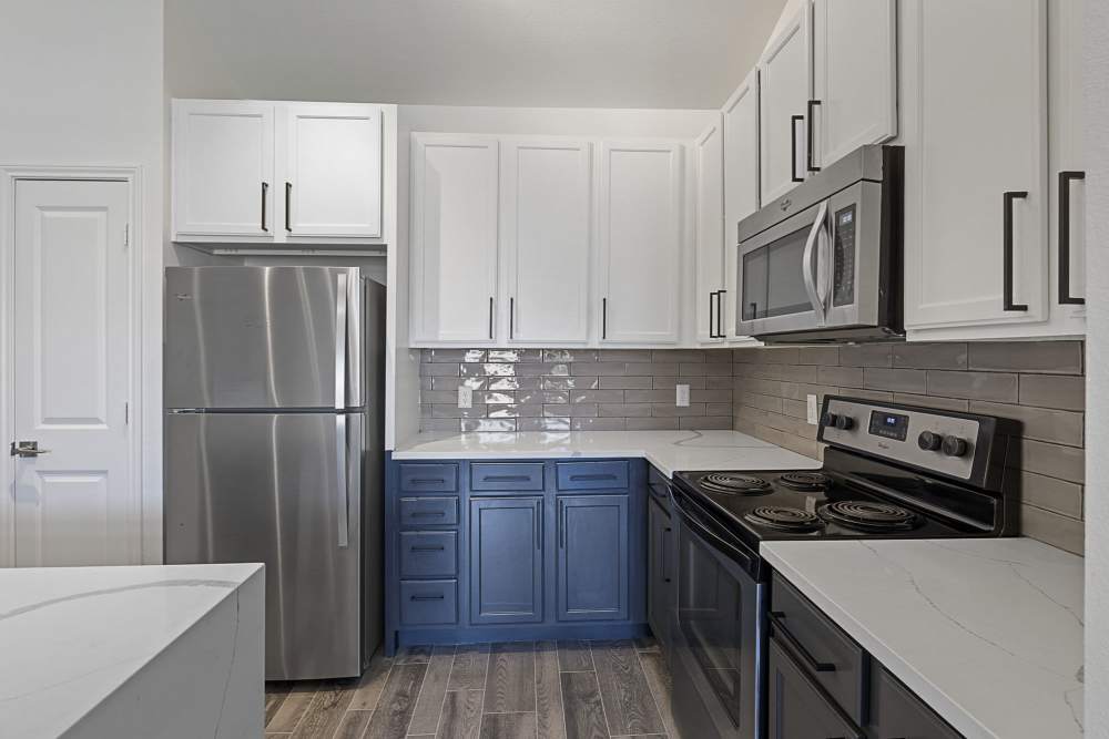 Kitchen with electric range at Ashwood in Pflugerville, Texas