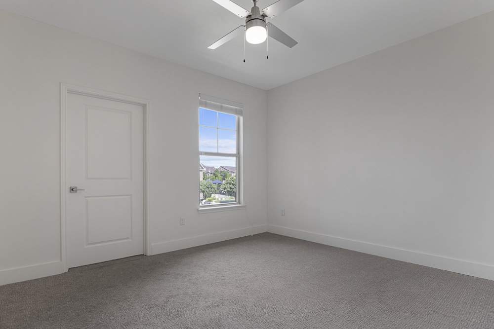 Bedroom with single window at Ashwood in Pflugerville, Texas