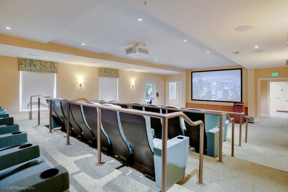 Theater room with chairs and a projector screen at The Meridian at Boca Raton in Boca Raton, Florida.
