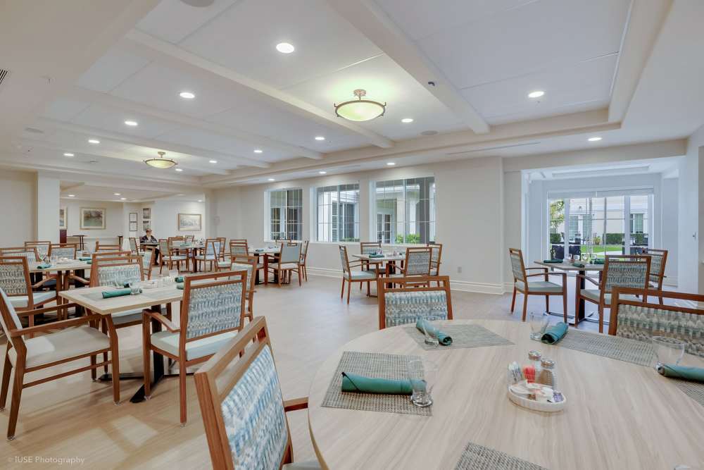 A dining room with tables and chairs at The Meridian at Boca Raton in Boca Raton, Florida.