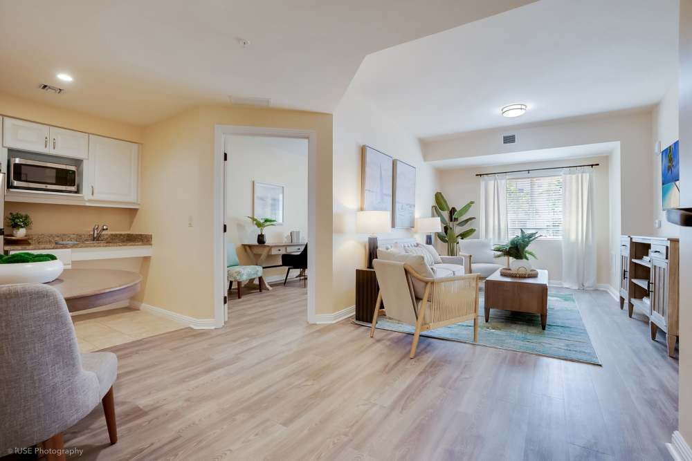 A modern living room and kitchen area in an apartment at The Meridian at Boca Raton in Boca Raton, Florida.