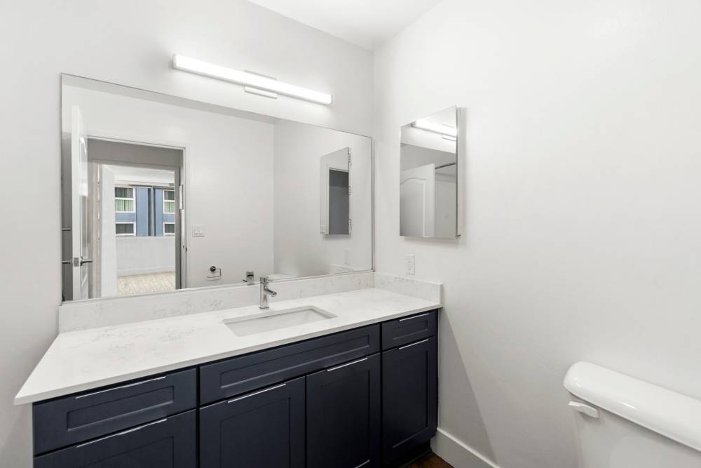 Large bathroom with cabinetry at 1900 Ocean Apartment Homes in Long Beach,California