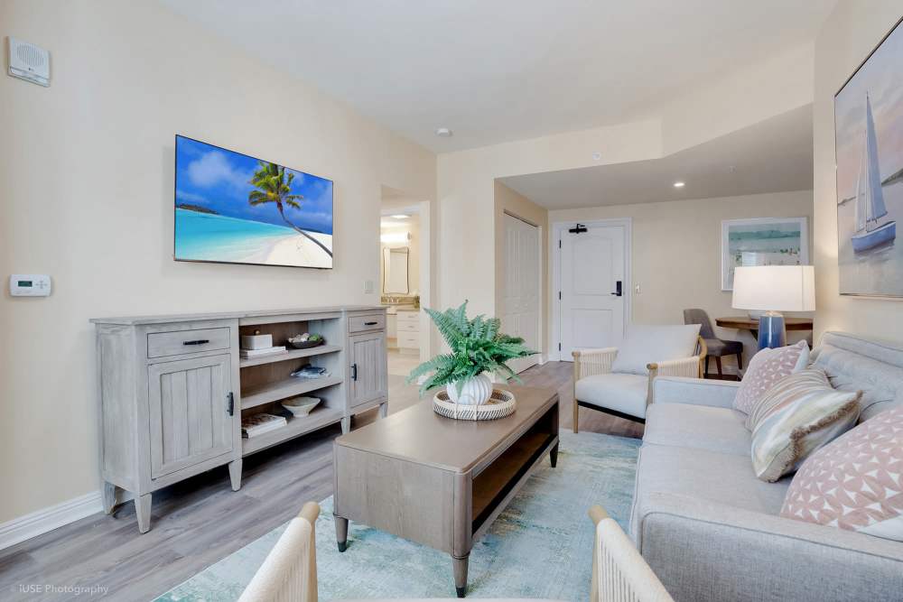 A cozy living room featuring a flat screen TV and a couch at The Meridian at Boca Raton in Boca Raton, Florida.