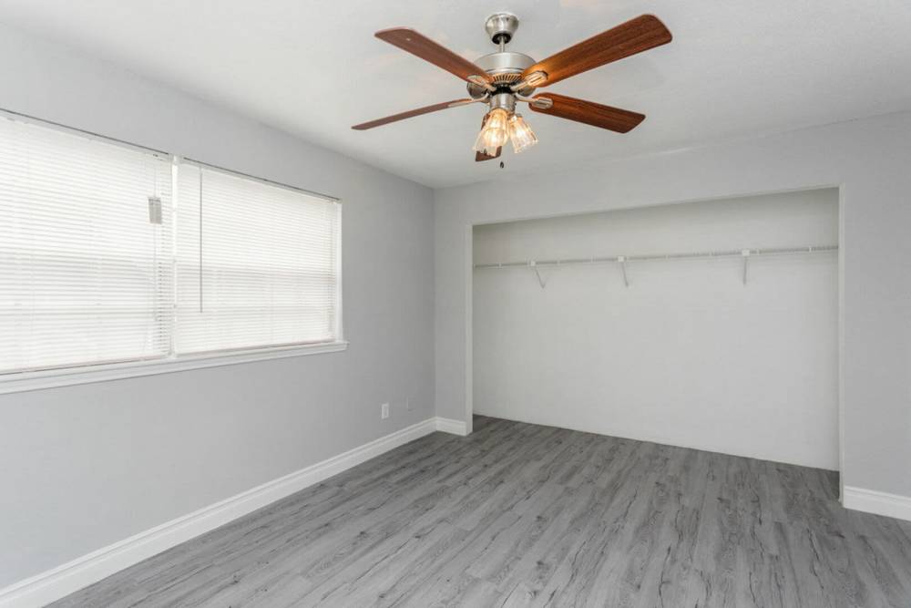 Bedroom with a closet area at Pine Lake Village in Houston, Texas