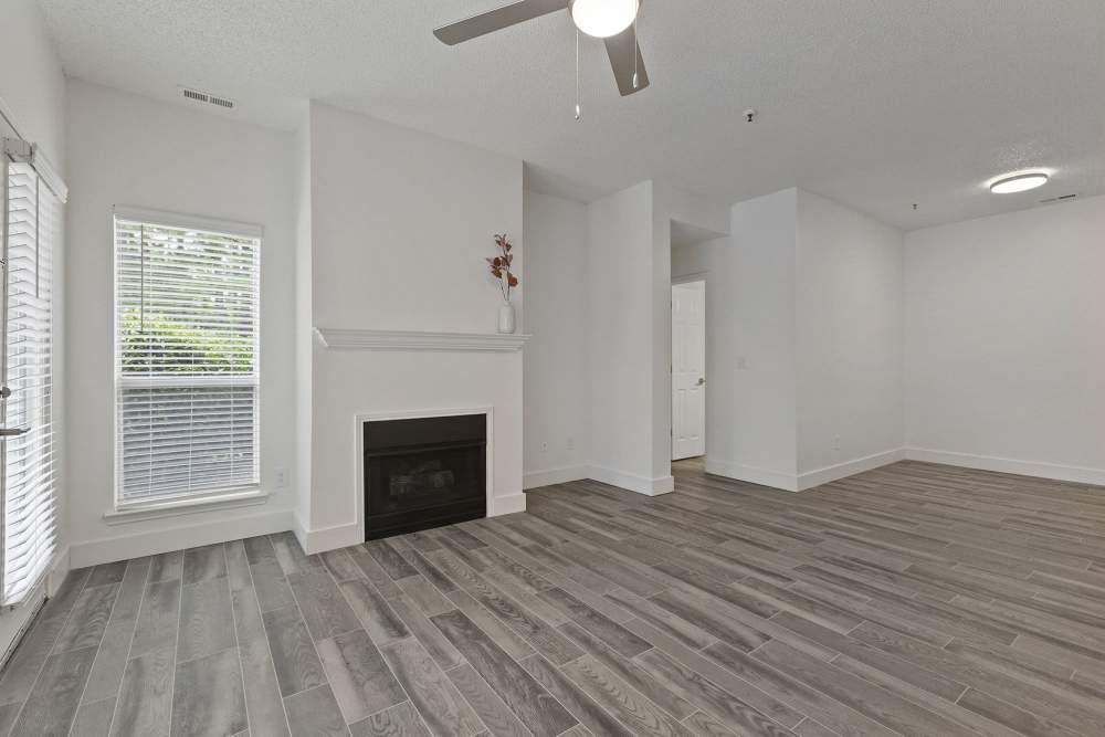 Unfurnished living room with fireplace at The Ashton in Raleigh, North Carolina