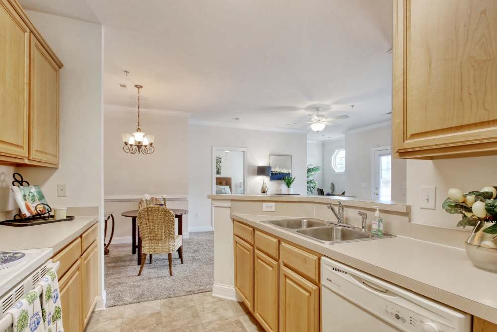 Kitchen features wooden cabinetry at Cloisters at Carolina Forest in Myrtle Beach, South Carolina