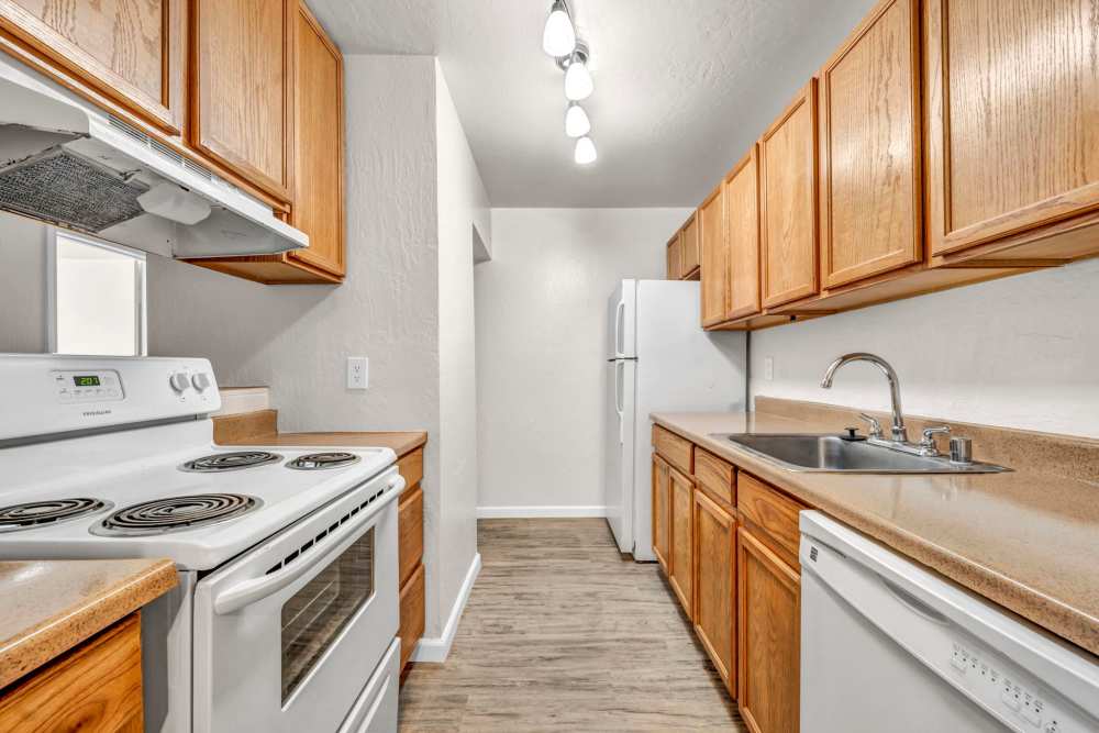 Kitchen with wooden cabinets at Riverwood Apartments in Reno, Nevada