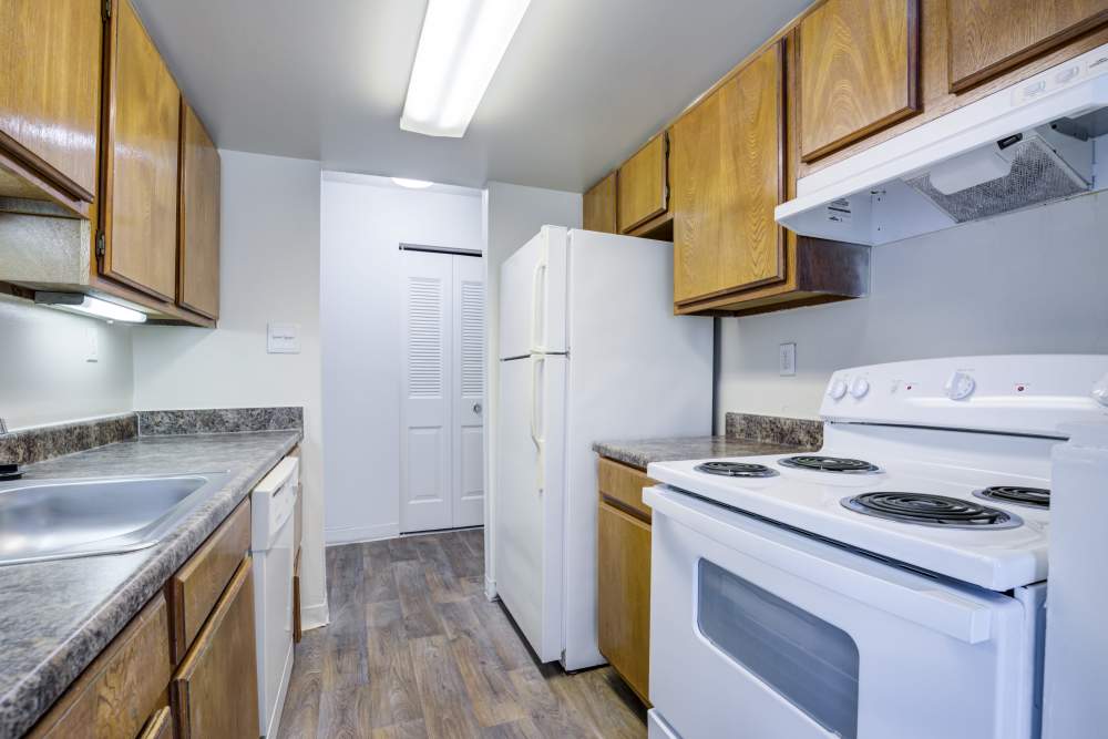 Kitchen with wooden cabinets at Preserve at Cradlerock Apartment Homes in Columbia, Maryland