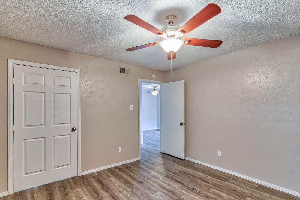 Bedroom with a ceiling fan at Oak Manor Apartments in Henderson, Texas