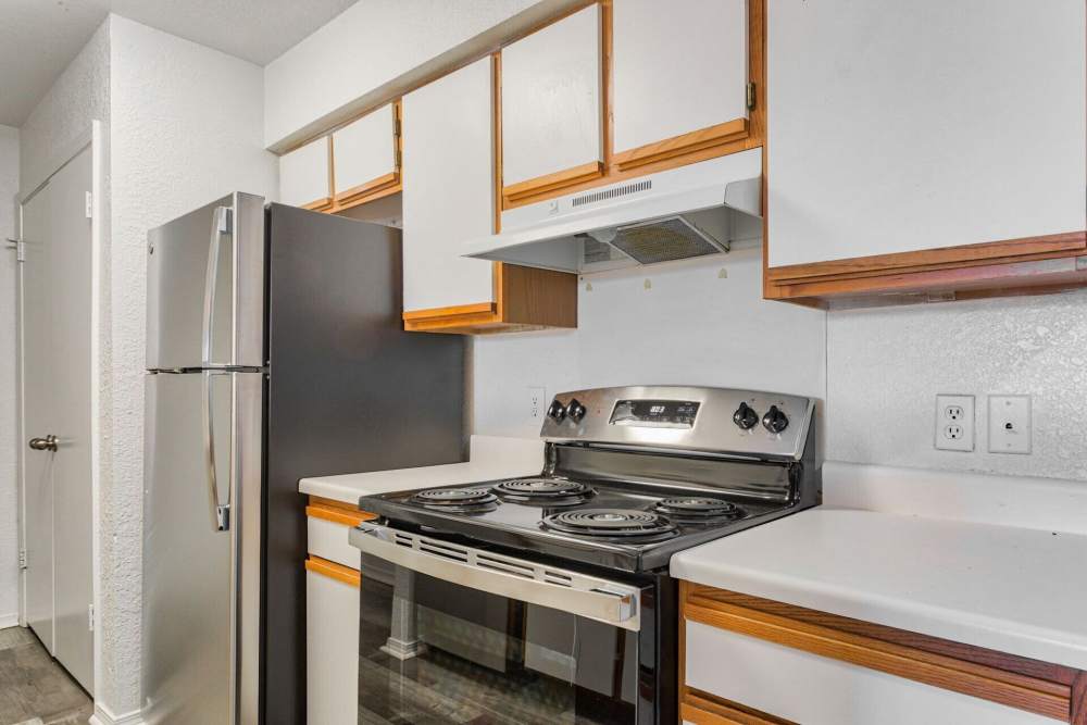 Cozy kitchen with white cabinetry and trendy appliances