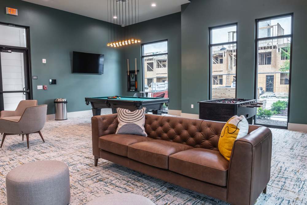 Gaming Room with Stylish Sofa and Large Windows at The Waters at Freeport in Freeport, Florida