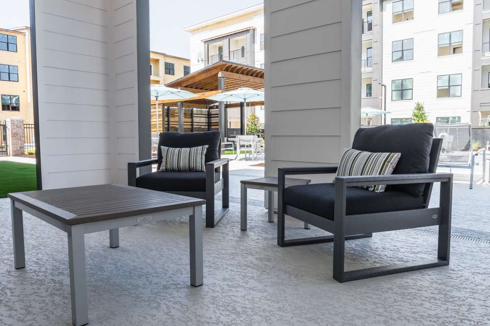Stylish outdoor lounges featuring black and gray tables at The Waters at Freeport in Freeport, Florida