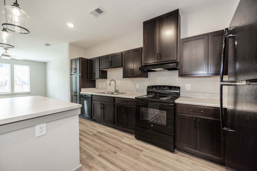 Model kitchen with pendant lights at Vanguard Apartments in Durham, North Carolina, 