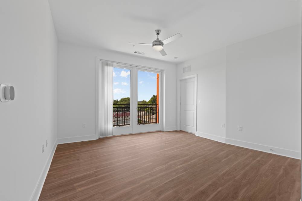 Bright and airy room with balcony access and modern design at Flats at College Park in College Park, Maryland