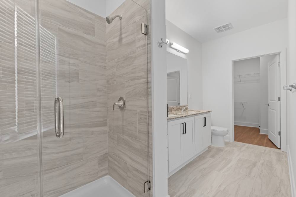 Sleek bathroom featuring a glass shower and modern finishes at Flats at College Park in College Park, Maryland